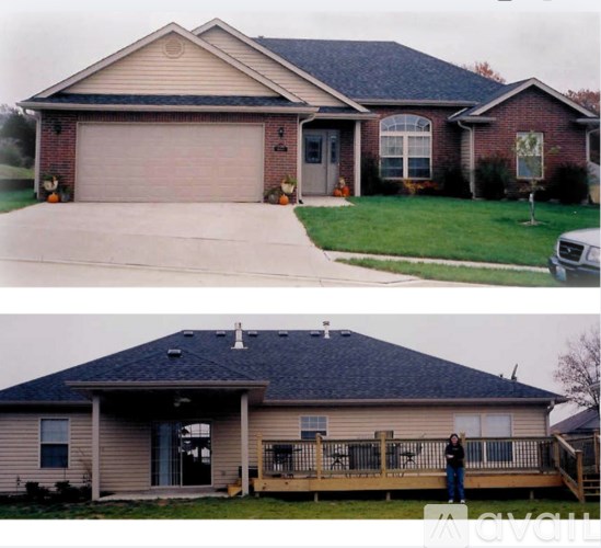 A house with a grey roof and a brown garage door.