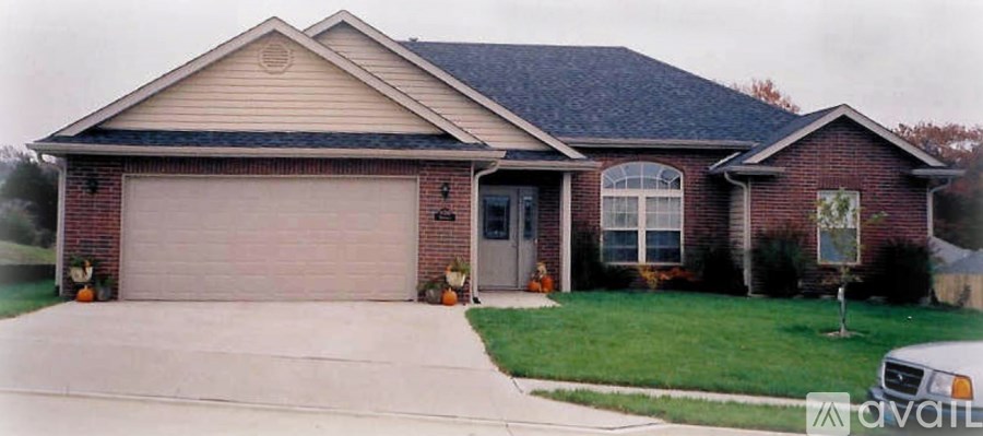 A house with a garage and a driveway in front.