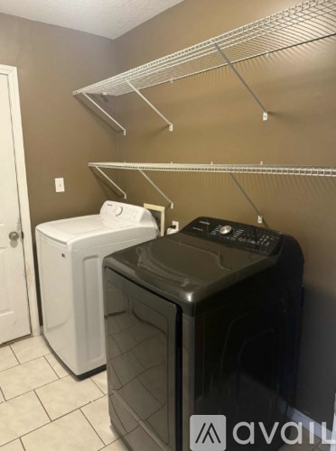 A laundry room with a washer and dryer.