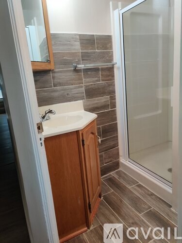 A bathroom with a sink and a shower.
