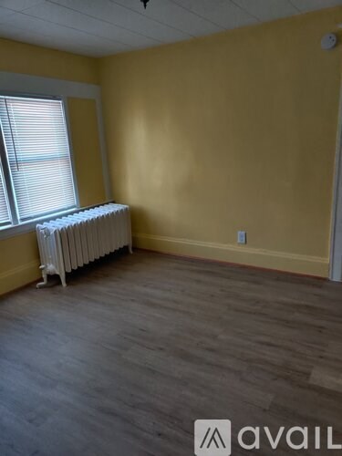 A room with a radiator and a window.