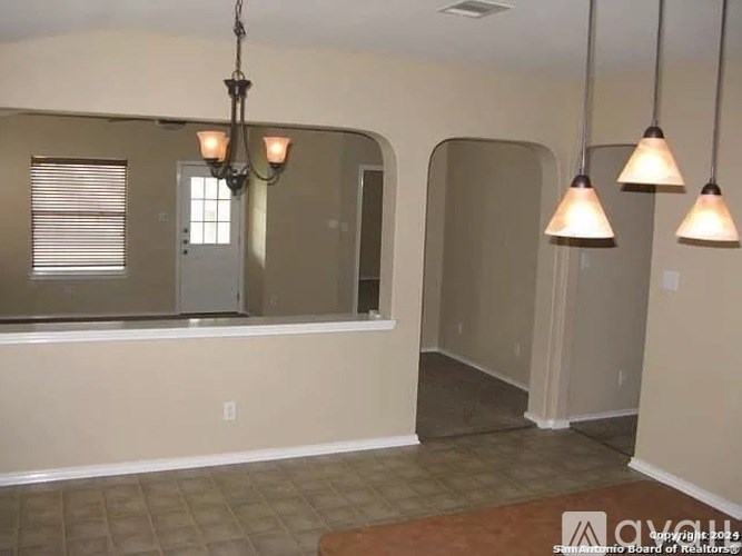 A room with a chandelier and a window.