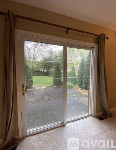 A room with a sliding glass door leading to a patio.