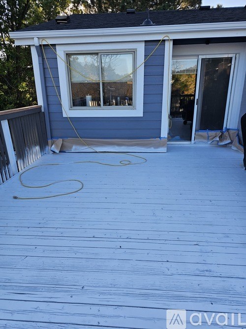 A wooden deck with a hose on it.
