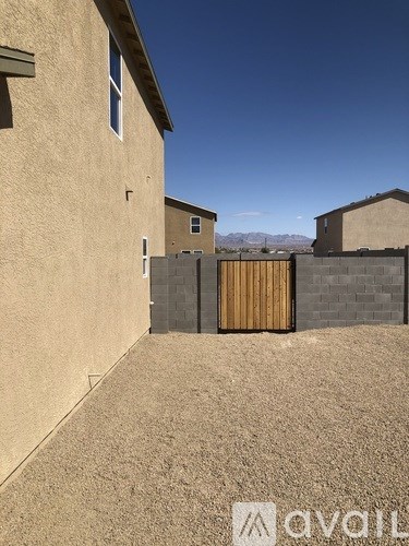 A house with a brown fence and a brown gate.