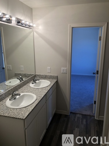 A bathroom with two sinks and a mirror.