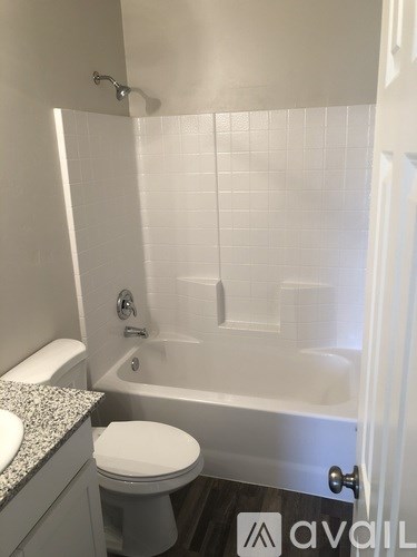 A white toilet sits next to a sink in a bathroom.