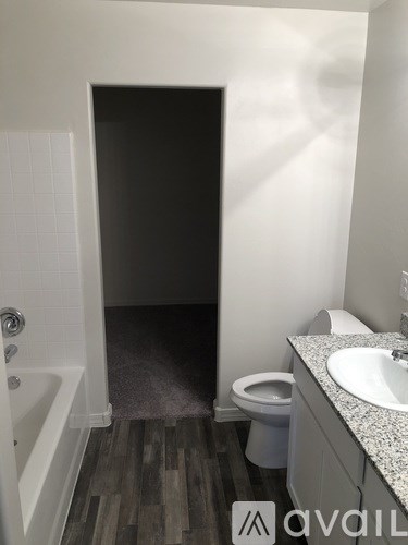 A bathroom with a toilet, sink, and bathtub.