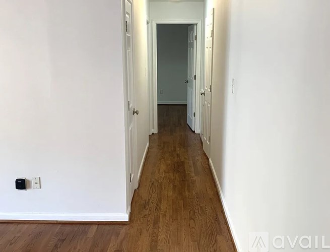 A long hallway with a door at the end.