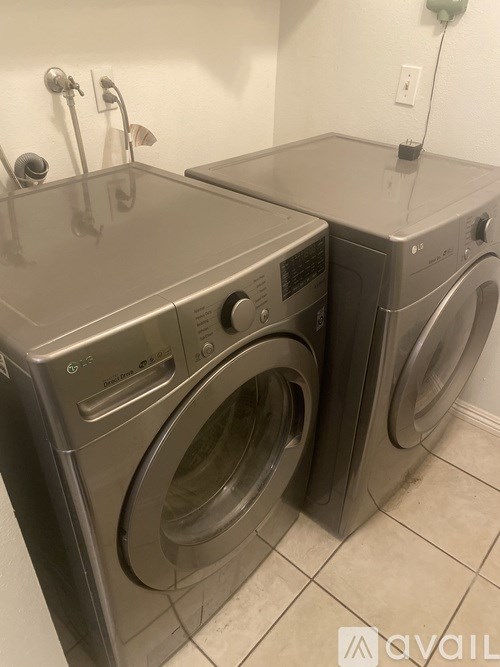Two front loading washing machines in a laundry room.