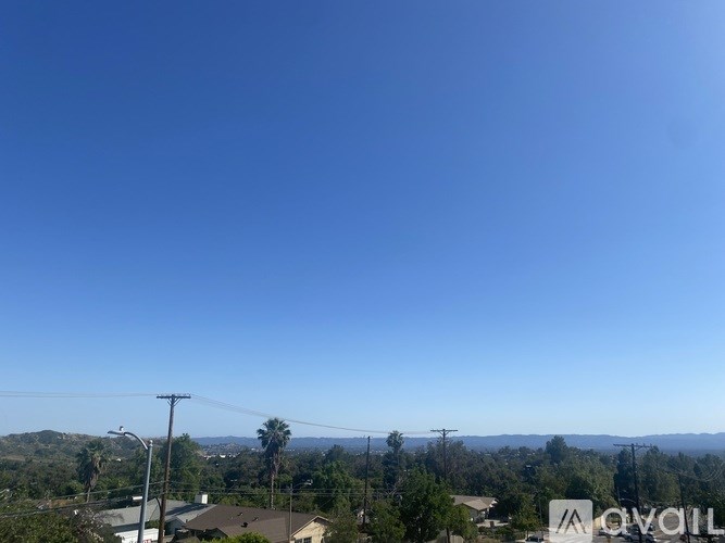 A clear blue sky with a few scattered clouds.