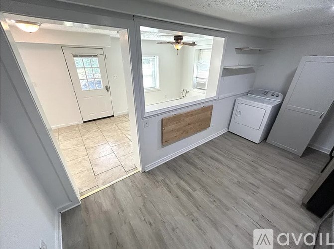 A room with a washer and dryer in it.