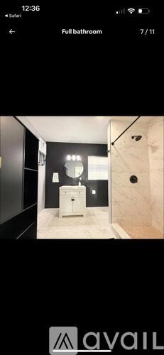 A bathroom with a toilet, sink, and mirror.