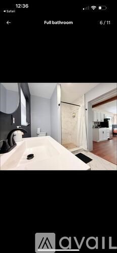 A bathroom with a white sink and a mirror.
