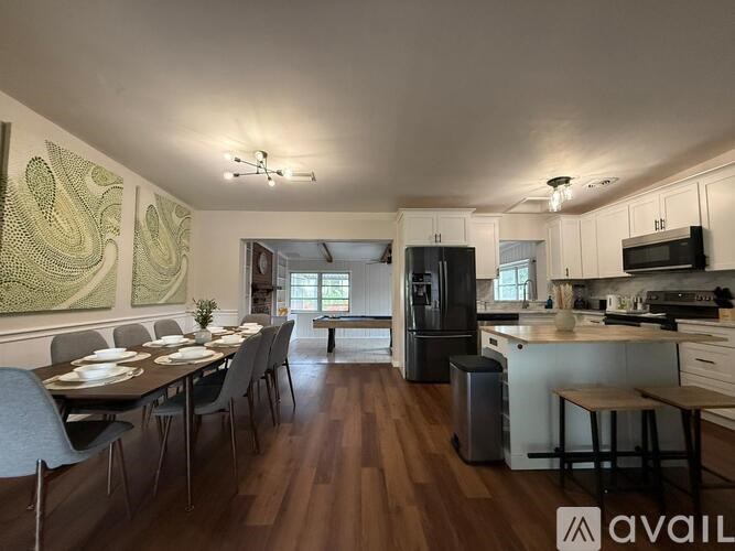 A modern kitchen with a dining table set for six.