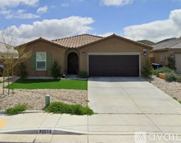 A house with a garage and a driveway in front.