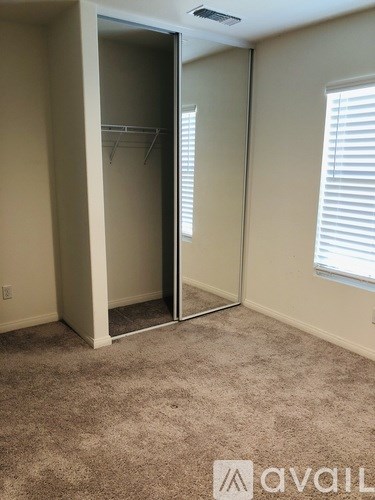 A room with a carpeted floor and a sliding door.