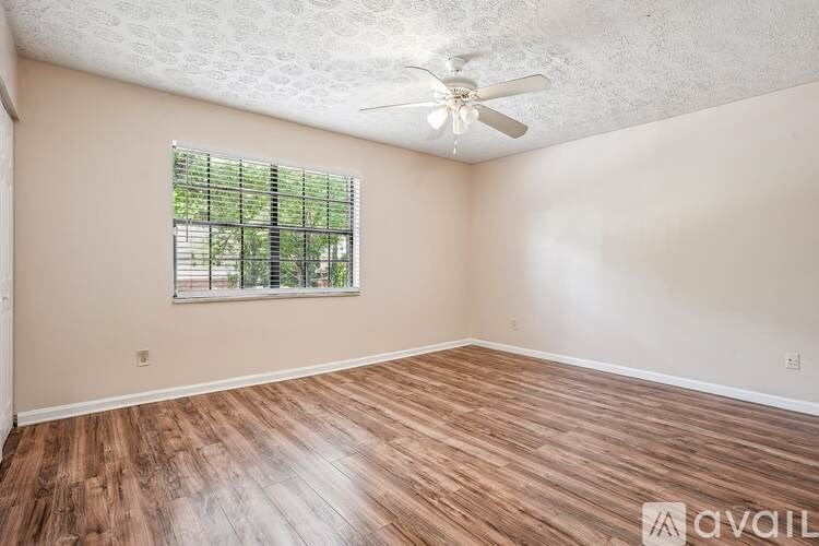 A room with a window and a fan.