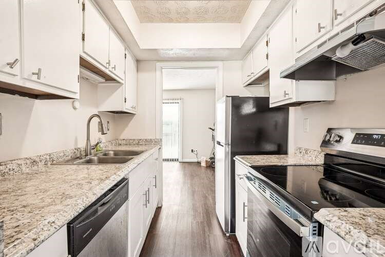 A kitchen with granite countertops and stainless steel appliances.