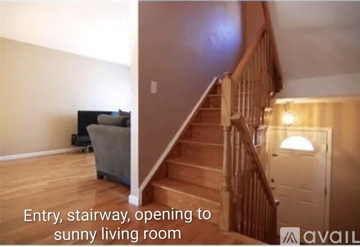 A stairway leading to a sunny living room.