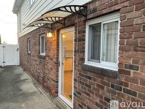 A house with a white door and window is available for rent.