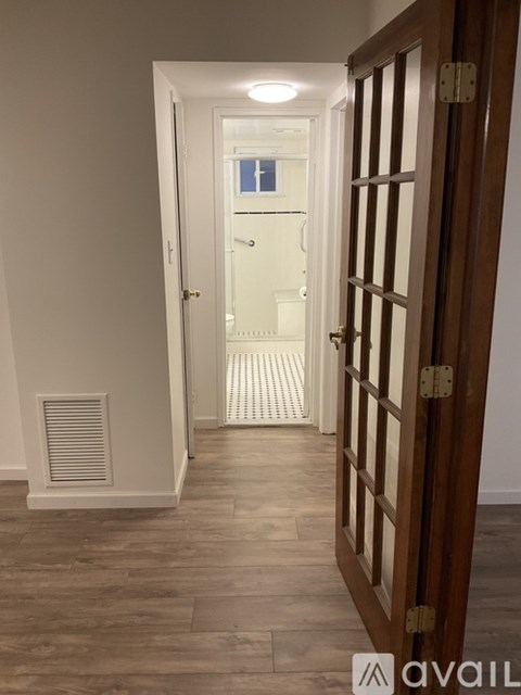 A hallway with a door on the left and a door on the right.