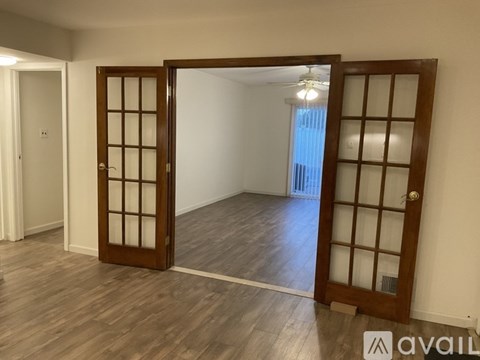 A room with a wooden floor and a sliding door.