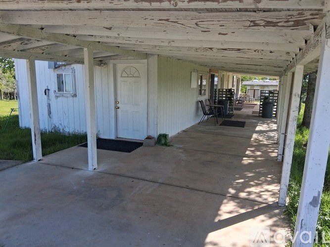 A white porch with a door and a window.