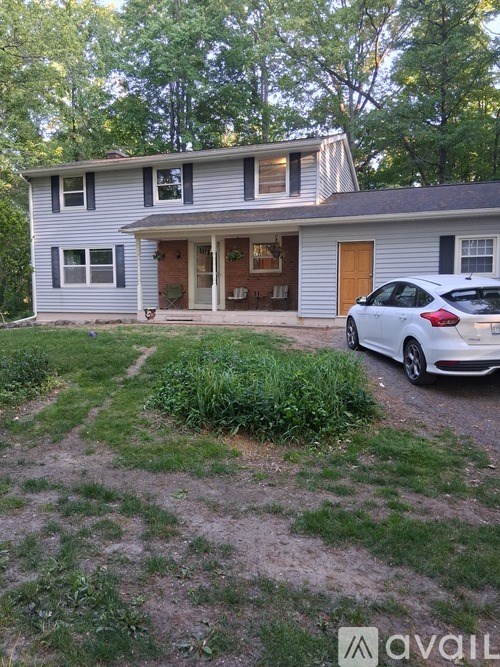 A house with a car parked in front of it.