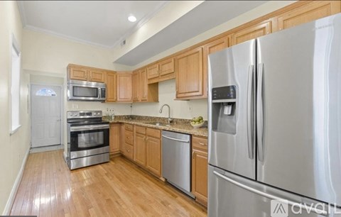 A kitchen with wooden cabinets and stainless steel appliances.