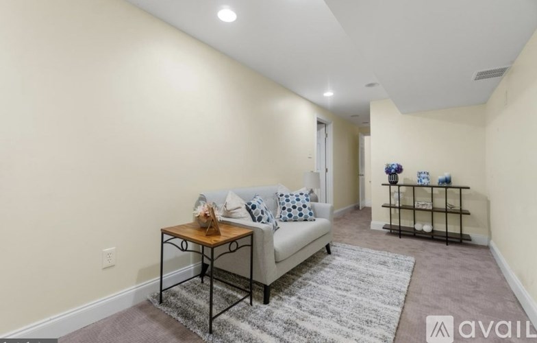 A living room with a sofa, a coffee table, and a rug.