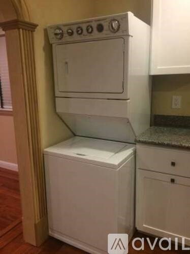 A white dishwasher and oven are installed in a kitchen.