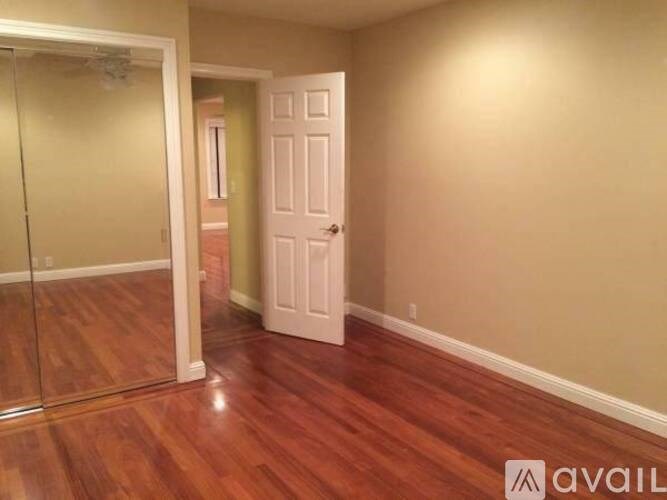 A room with a white door and a glass door.