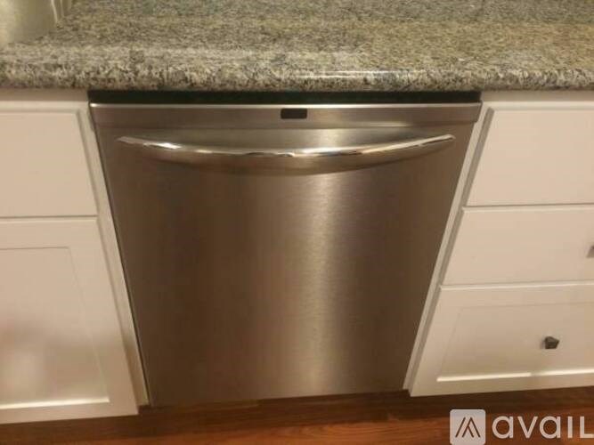 A stainless steel dishwasher is installed in a kitchen.