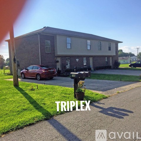 A house with the word "TRIPLEX" written on it.