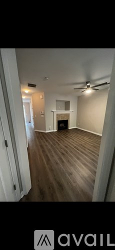 A room with wooden floors and a fireplace.