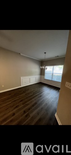 A room with wooden flooring and a window.