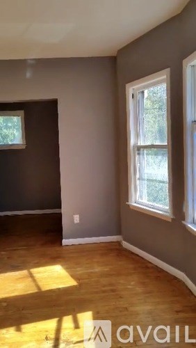 A room with wooden floors and a window.