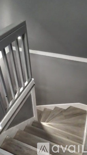 A staircase with a metal railing and wooden steps.