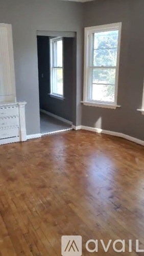 A room with wooden floors and white walls.