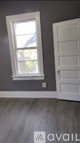 A room with a white door and a window with a white frame.