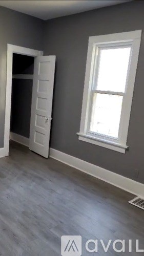 A room with a white door and a window.