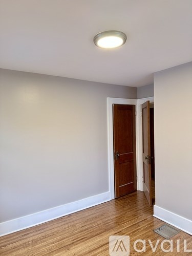 A room with a wooden floor and a ceiling light.