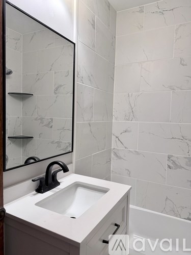 A bathroom with a sink and a mirror.