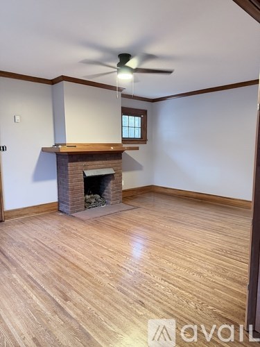 A room with a fireplace and a ceiling fan.