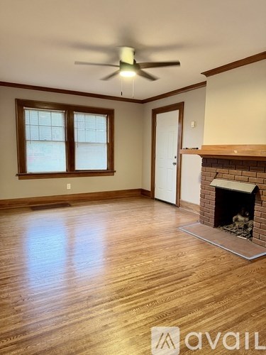 A room with a fireplace and a ceiling fan.