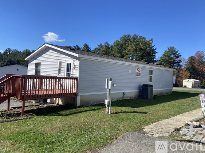 A mobile home with a deck and a covered patio.
