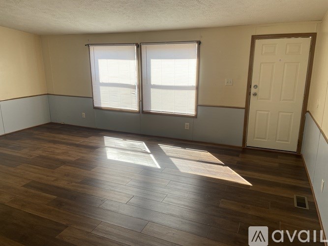 A room with wooden floors and a white door.