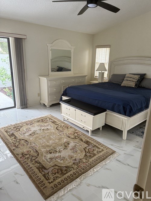 A bedroom with a bed, dresser, and mirror.