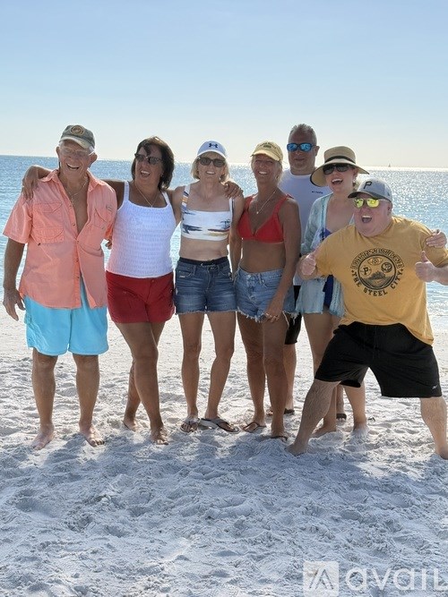 A group of people are standing on a beach.